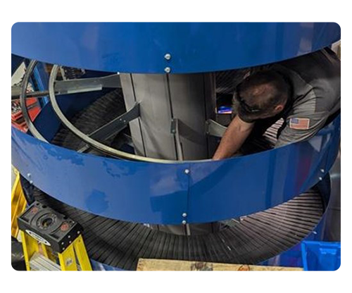 Carolina Handling technician repairing spiral conveyor