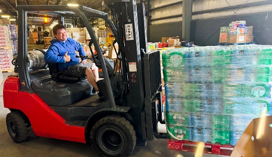 Carolina Handling employees helps distribute water after hurricane helene.