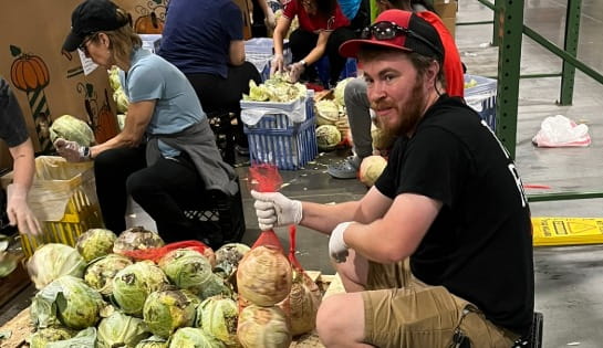 Carolina Handling associate volunteering packing food. 