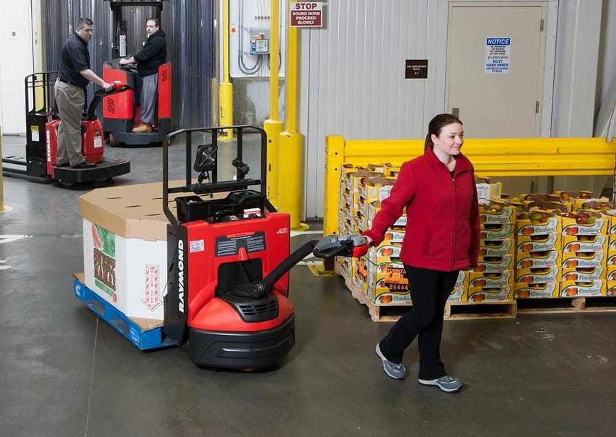 Raymond 8210 motorized pallet jack in action moving goods.