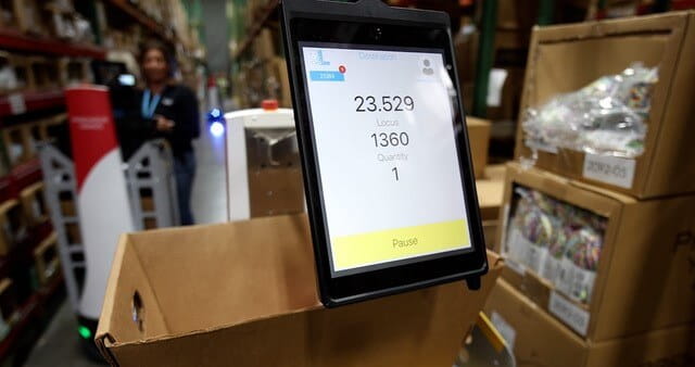 Screens attached to mobile robots identify picking location and quantity to be picked.