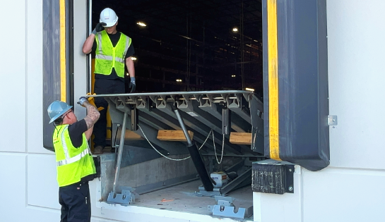 Carolina Handling Technicians repairing a dock door. 