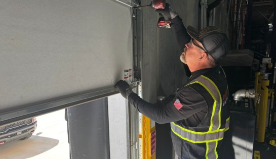 Tech installing new dock door.
