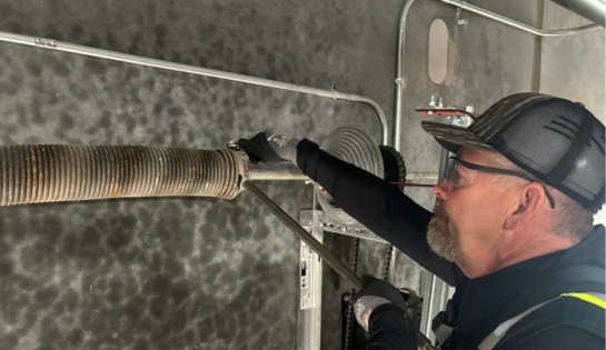 Tech inspecting dock door part. 